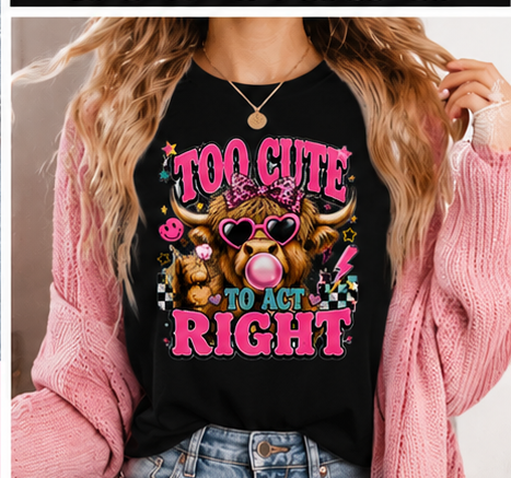 A collage showing a black graphic T-shirt with a cartoon cow wearing pink sunglasses and a pink bow, plus the text 'TOO CUTE TO ACT RIGHT' in pink and blue. The layout includes a flat-lay with pink sneakers, denim shorts, and a heart-shaped accessory, a close-up of the shirt graphic, a model wearing the shirt, and a pink banner at the bottom reading 'Highland Cow T-Shirts' with size information.