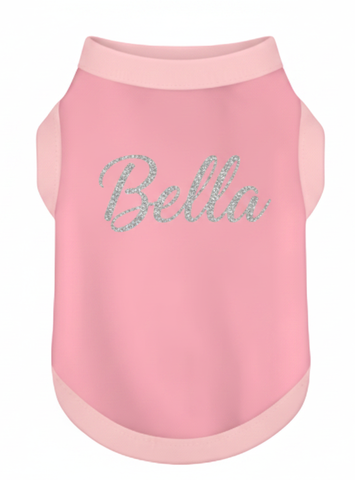 Pink dog shirt with 'Bella' in rhinestones on a white background
