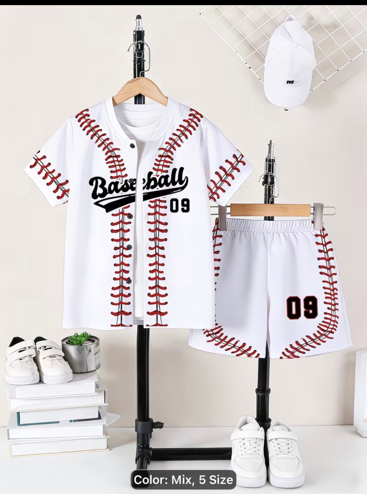 Baseball -themed children's outfit with jacket, shorts, and shoes on hangers against a neutral background.