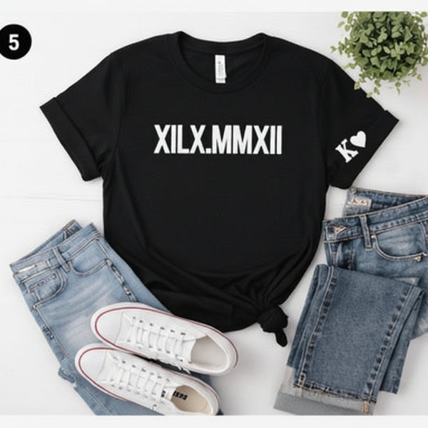 Black t-shirt with 'XILX.MMXX' text, paired with jeans and sneakers on a light background