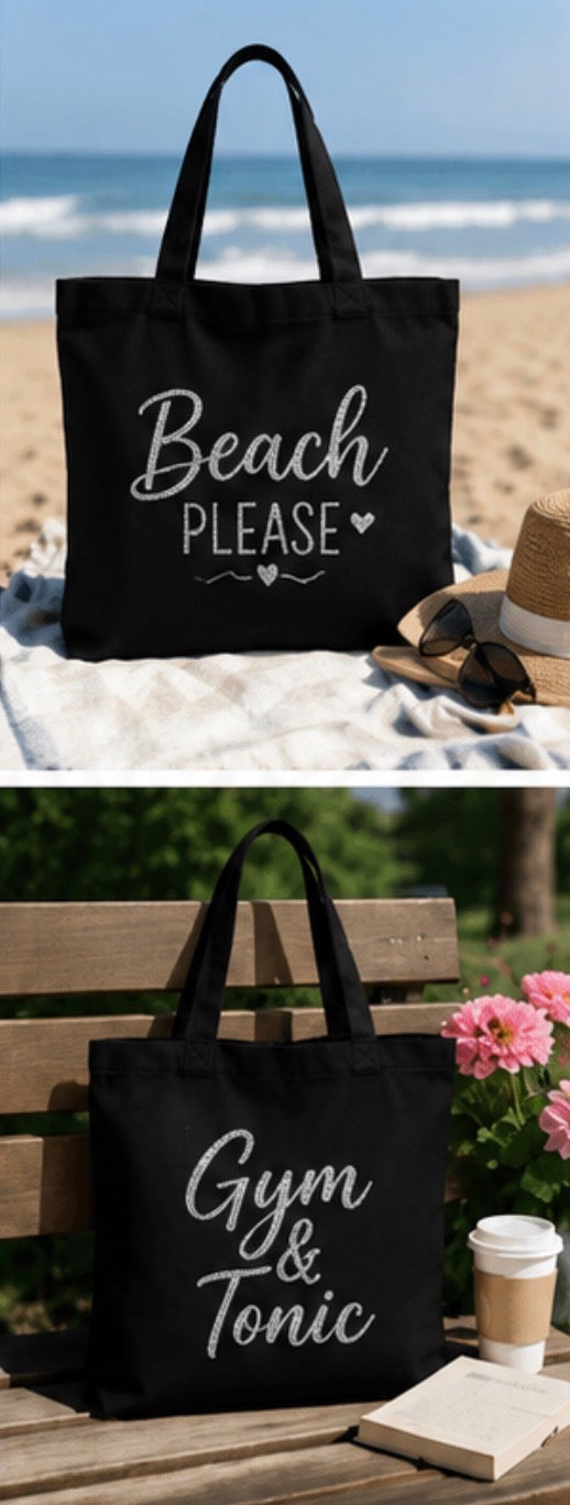 A black canvas tote bag with white text reading 'Beach PLEASE' in the top photo and 'Gym & Tonic' in the bottom photo, shown in beach and gym-like outdoor settings with props like sand, sunglasses, hat, flowers, and a coffee cup.