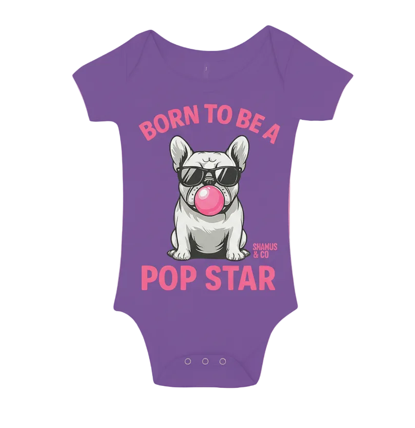 White baby onesie by Shamus & Co with "Born to be a Pop Star" printed text, featuring snap buttons at the bottom.