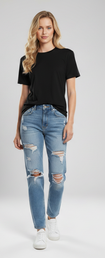 Woman wearing a black t-shirt and ripped jeans on a white background