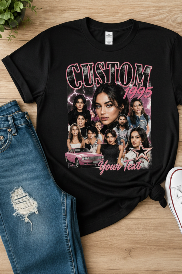 Black t-shirt with graphic design and text on a wooden surface with jeans and sneakers.