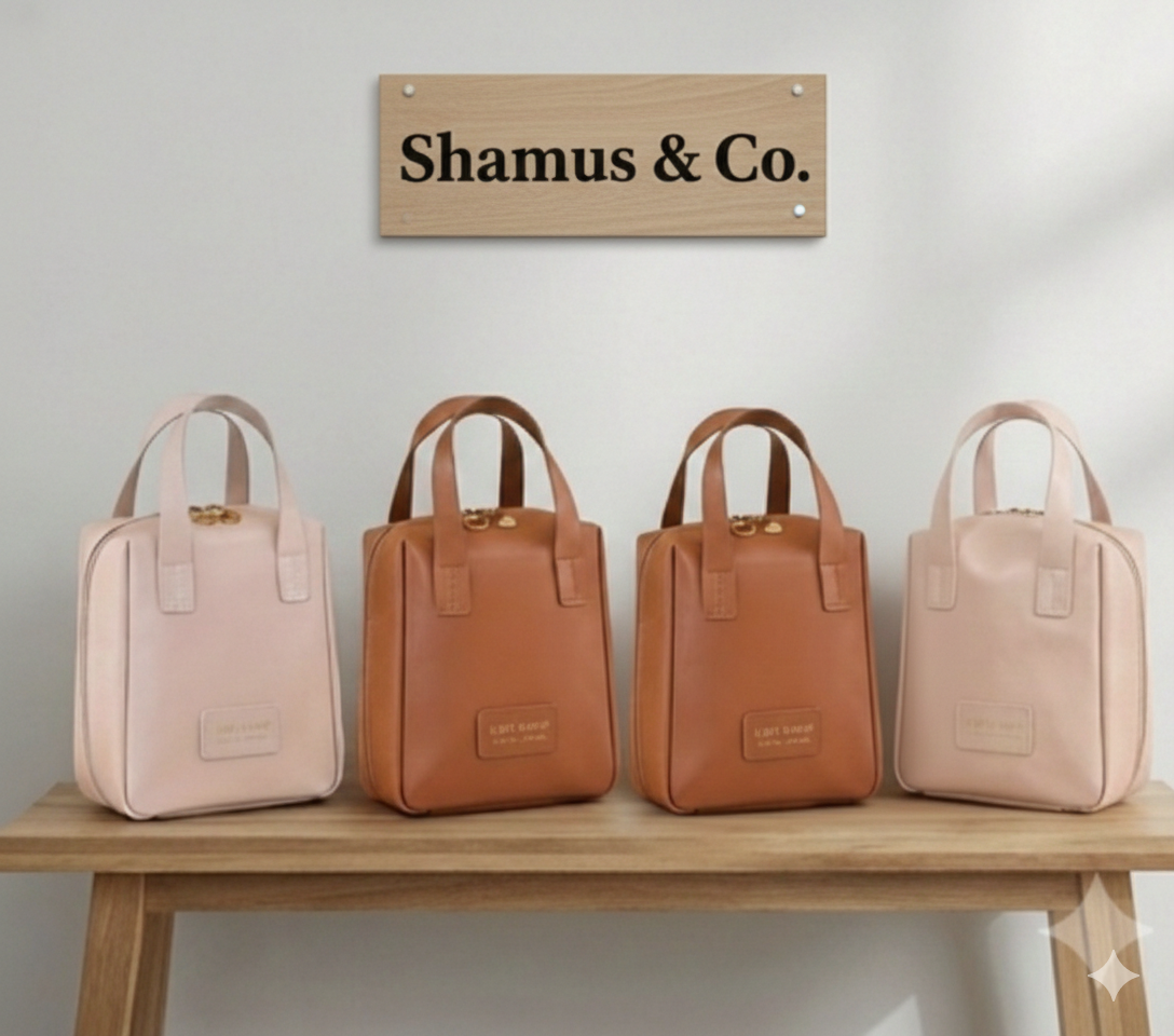 Four handbags in pink and brown on a wooden table with 'Shamus & Co.' sign above.