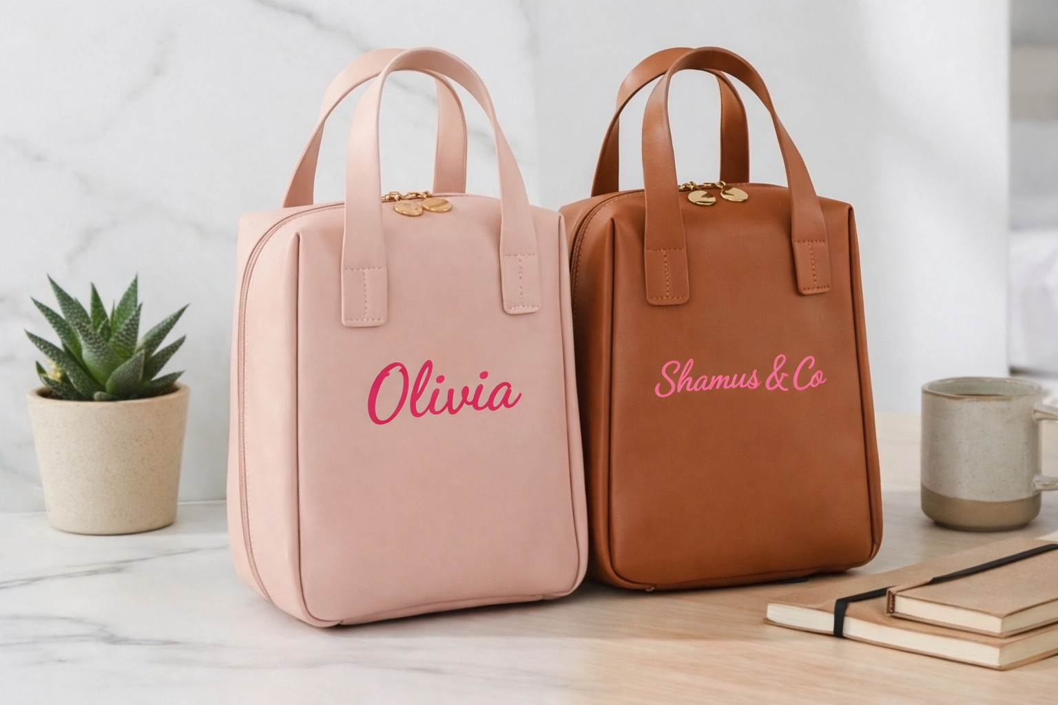 Two bags, one pink and one brown, with personalized names on a light surface.