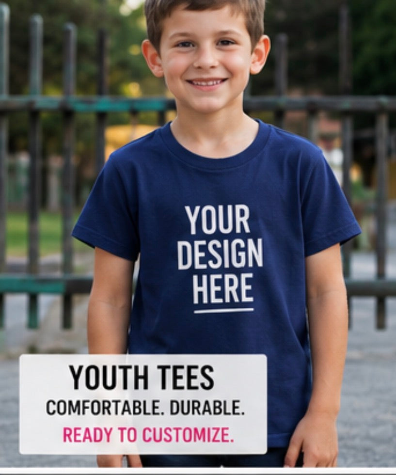 A smiling young boy wearing a navy blue custom graphic t-shirt with white placeholder text reading 'YOUR DESIGN HERE'. A white banner at the bottom reads 'YOUTH TEES COMFORTABLE.