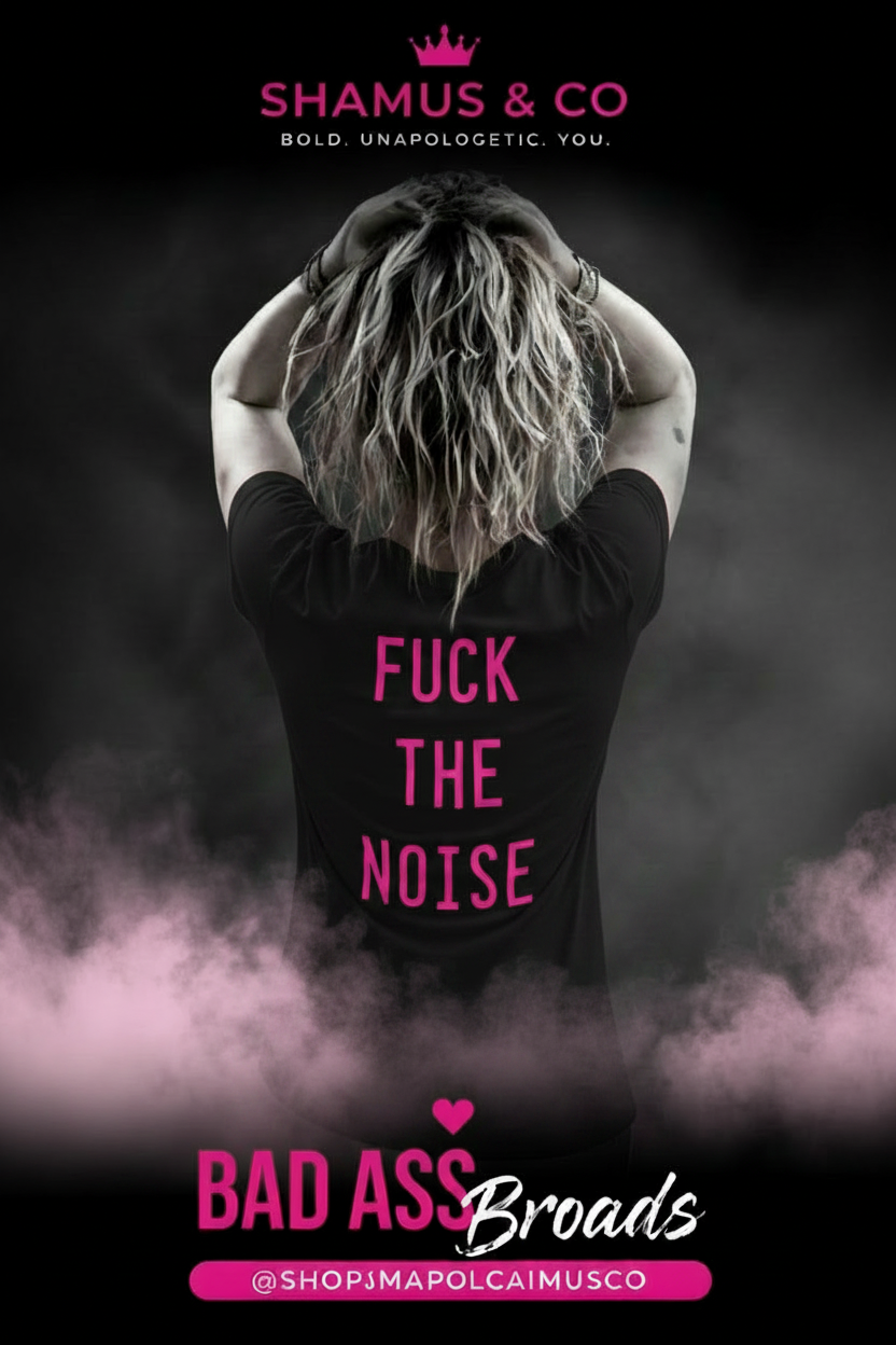 Person wearing a pink shirt with text, standing in front of a dark background with smoke effects.