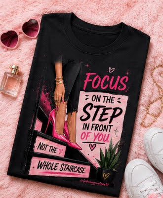 Black t-shirt with motivational quote on a pink background