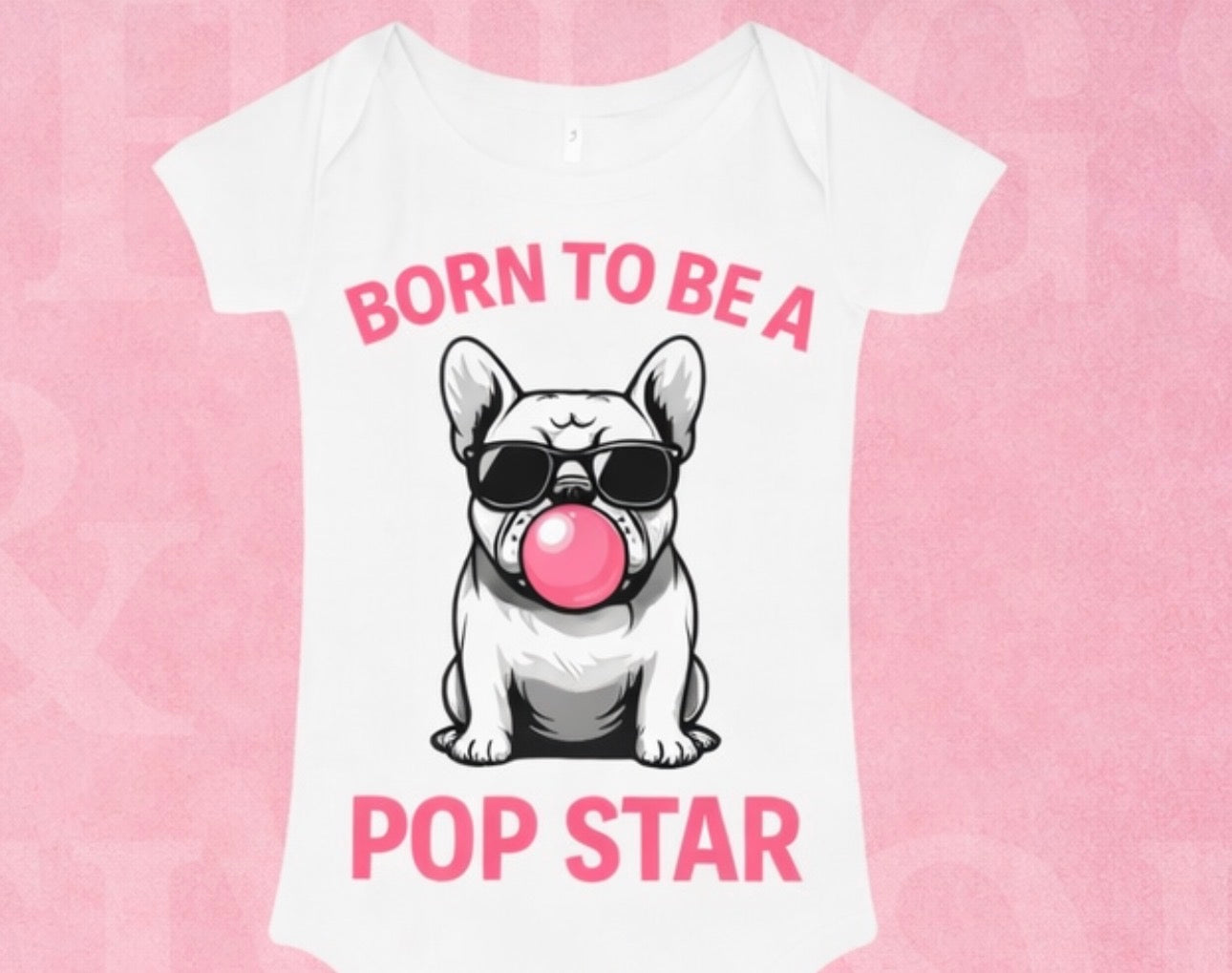 Baby wearing a "Born to be a POP STAR" Shamus & Co onesie with colorful star and music note prints on a white background.