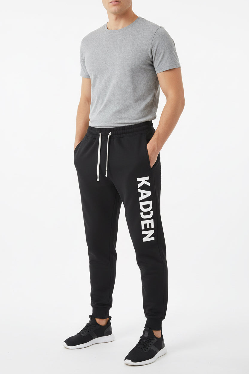 Set of six pairs of jogger pants in different colors on a white background.