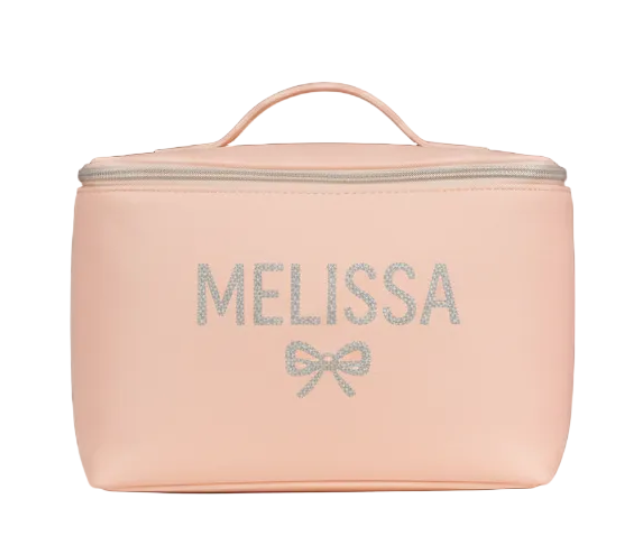 Pink cosmetic bag with 'Melissa' and a bow design on a white background