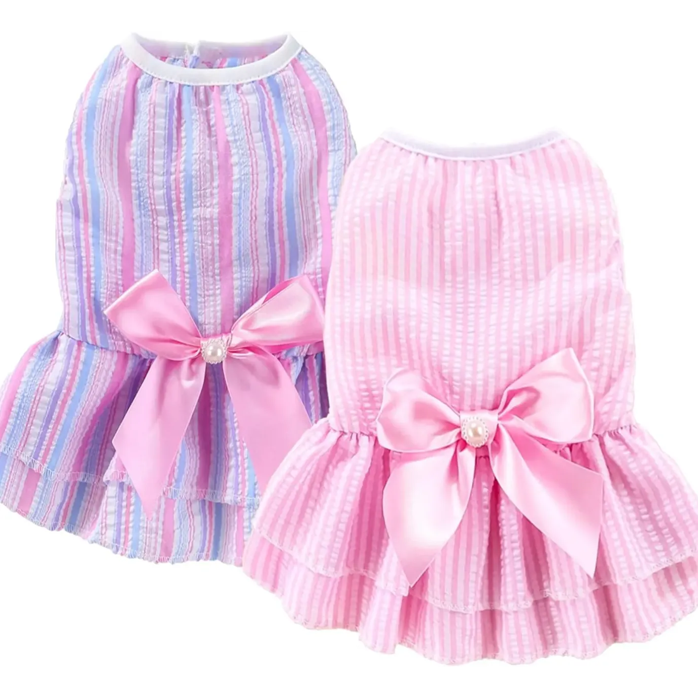 Two pet dresses with pink bows on a white background
