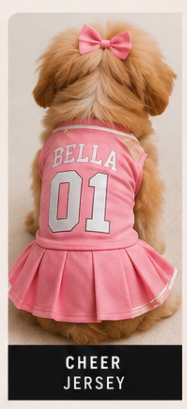 Dog wearing a pink cheerleader outfit with 'Bella 01' on a neutral background