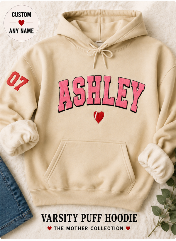 Beige hoodie with 'ASHLEY' printed in pink on a light background