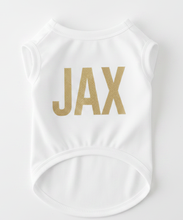 White sleeveless top with 'JAX' printed in gold on a white background