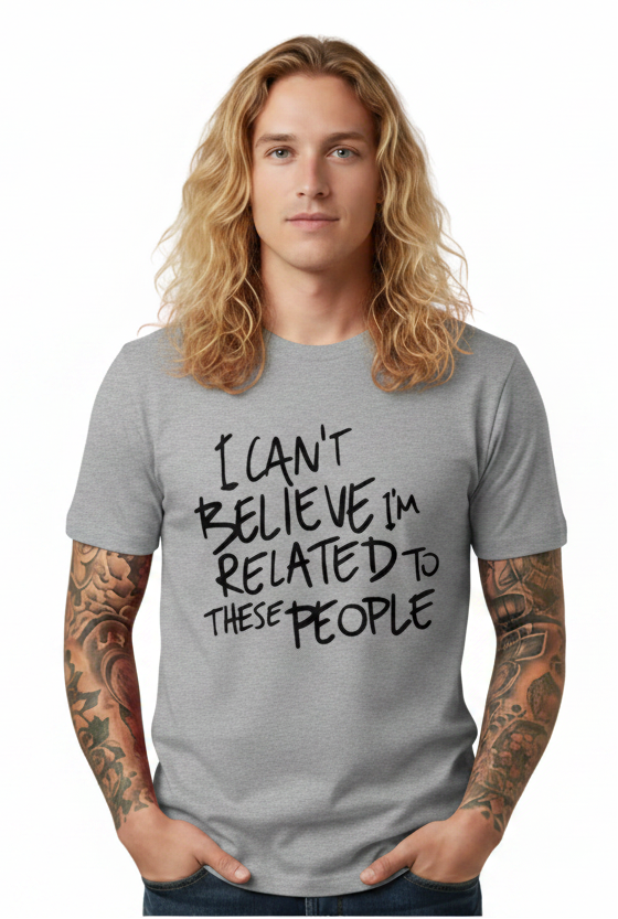 Man wearing a gray t-shirt with text, standing against a white background