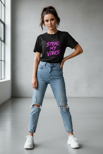 Woman wearing a black t-shirt with colorful text and ripped jeans in a minimalistic setting
